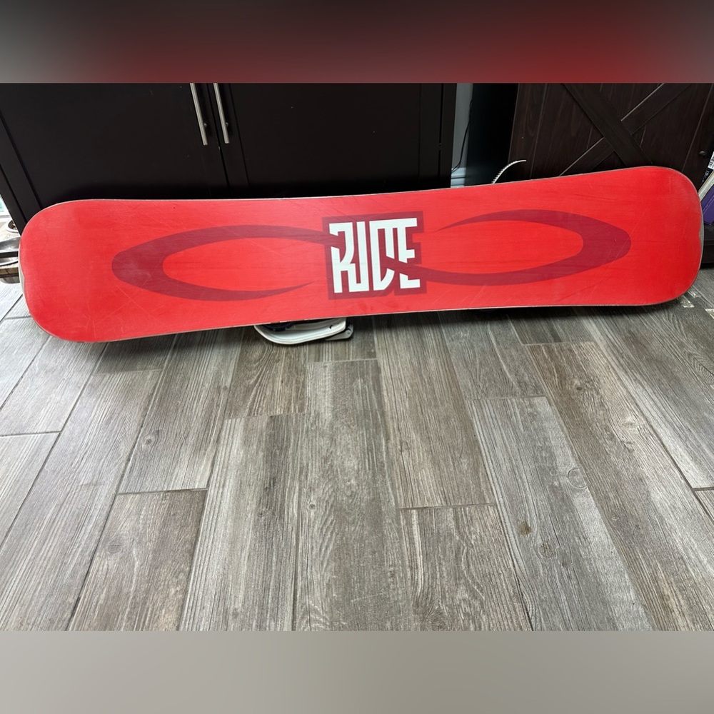 Dakine Ride snowboard, Dakine double board bag and Rage snowboard boots.